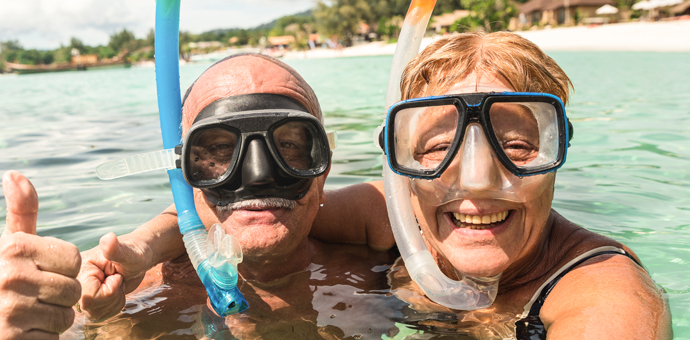 Couple in the water snorkeling together.