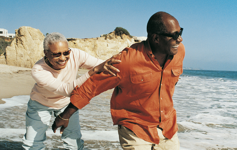 Couple having fun and playing together at the beach.