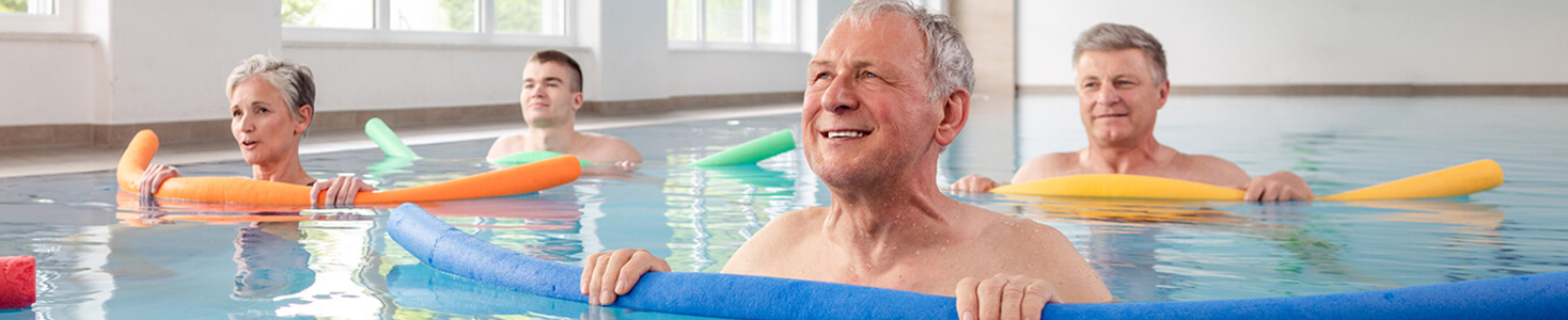 Group of people exercising in a pool together.