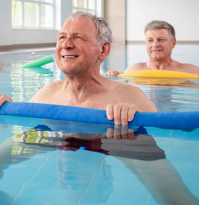 Group of people exercising in a pool together.