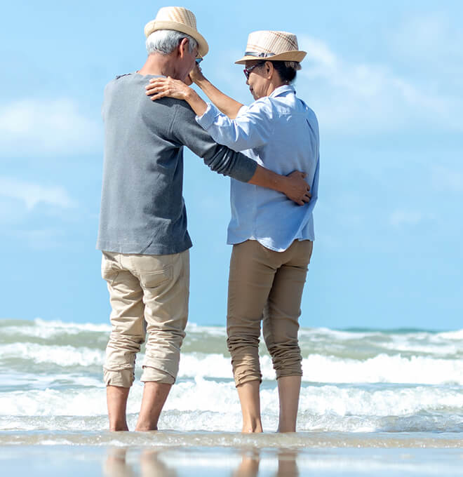 Couple dancing together by the beach.